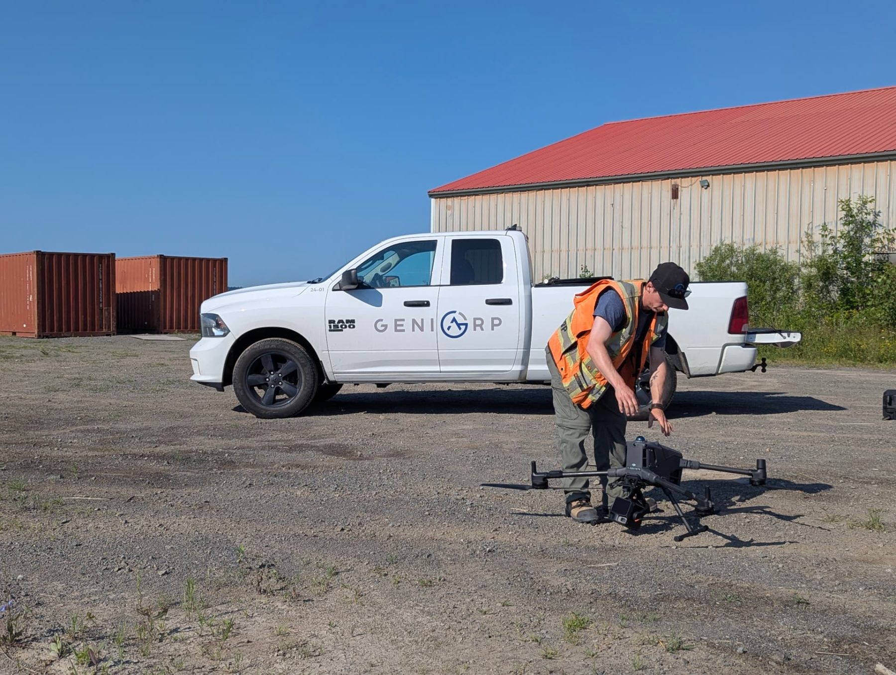 Géniarp technician preparing survey equipment beside the service truck